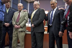 Clark County Commissioners Steve Stuart, second left, Tom Mielke, center, and David Madore, second from right, pray after Madore and Mielke took the oath of office at the County Services Building on Jan. 2, 2013. - Photo by Zachary Kaufman