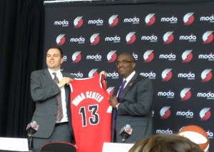Blazers team president Chris McGowan and Moda Health president Dr. William Johnson welcome in the new Moda Center era with the traditional jersey-pose for the cameras.