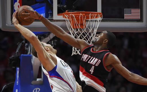Los Angeles Clippers forward Blake Griffin, left, goes up for a dunk as Portland Trail Blazers forward Maurice Harkless defends during the second half in Game 2 of a first-round NBA basketball playoff series, Wednesday, April 20, 2016, in Los Angeles. The Clippers won 102-81. (AP Photo/Mark J. Terrill)