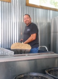 Cody Gray, Co-Founder of the Vancouver Brewfest shoveling out the mash tun of the official brew of the Vancouver Brewfest at Heathen Brewing