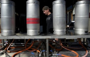 Heathen co-owner and brewer Sunny Parsons washes kegs on a Saturday afternoon. His business is growing rapidly, and he hopes to open a brewpub soon. (Photo by Zachary Kaufman)