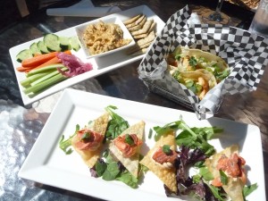 Salmon wontons, red snapper fish tacos, and hummus platter at Farrar's Bistro. The weather might not tempt you outside right now but the menu's visit-worthy year round. 