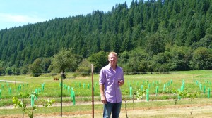 Pomeroy Cellars' winemaker, Daniel Brink, standing in front of a block of estate-growing Pinot Noir grapes 