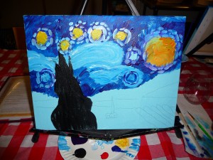 I chose my spot, donned a mustard yellow apron and set to work painting within the outlines of stars, comets, trees and sky that Sharon had drawn on each canvas. 