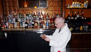 Dennis of Birch Street Uptown Lounge surveying the process thoughtfully as he caramelizes a sugar rim. 
