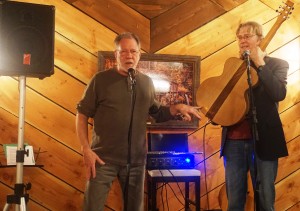 Guitar maker and local musician, Loren Schulte, explaining his inspiration for his second oak stave guitar before Doug Smith trials his handiwork. Viki Eierdam 