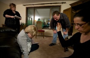 A group of mediums from White Light Paranormal Insight work with Patricia Lelevier, right, to investigate spirits in her home. Lelevier captured several strange noises on a voice recorder, which she played for the investigators. (Photo by Steven Lane)