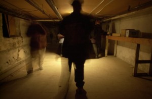 A member of the "Ghost Hunters" checks the basement of The Academy for orbs and other spirits.(Steven Lane/The Columbian)