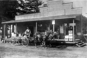 Coy Blair operator of East Mill Plain general store pictured in wagon about 1909. Sign say's "Bay State House Paint."
