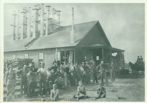 Workers pose for a photo outside the Old Blair Prune Dryer.