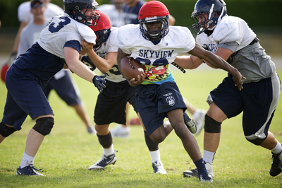 Skyview High School football running back Josh Emmy breaks away from tacklers at practice Tuesday August 27, 2013 in Vancouver, Washington. (Troy Wayrynen/The Columbian)