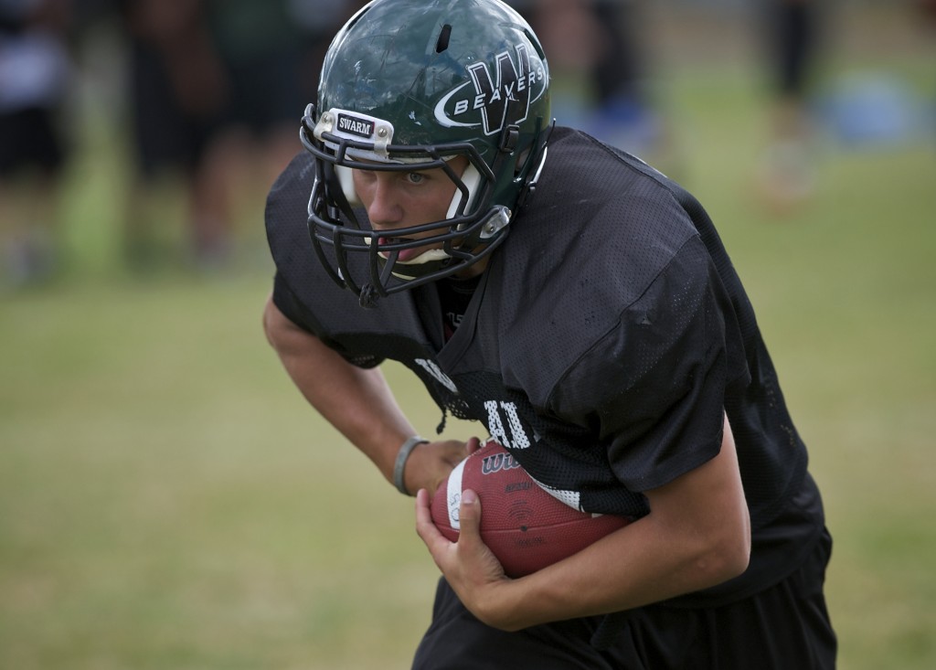 Woodland High School's Ely Whitmire runs a play during practice at WHS on Tuesday August 28, 2012. (Zachary Kaufman/The Columbian)