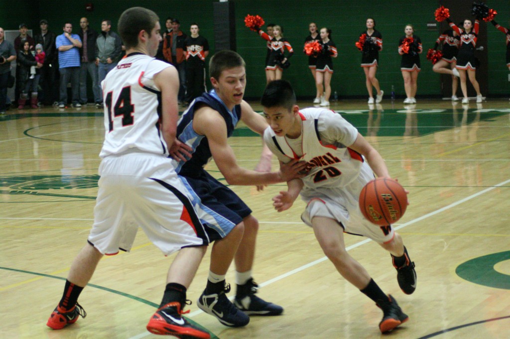 Sean Guthrie sets a screen for Austin Tran during the consolation finals of the district tournament Feb. 19, at Evergreen High School. Washougal and Hockinson battled into overtime, where the Hawks prevailed 67-53.