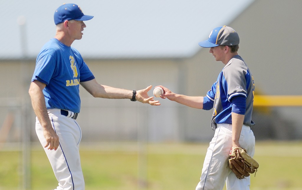 In this photo taken on Tuesday, May 13, 2014,Rochester High School head baseball coach Jerry Striegel removes starting pitcher Dylan Fosnacht from the mound after Fosnacht pitched a shutout into the 15th inning of a District IV 1A baseball tournament first-round game at Rochester High School in Rochester, Wash. Fosnacht threw 194 pitches as he took a shutout into the 15th inning. His team beat La Center 1-0 in 17 innings. (AP Photo/The Chronicle, Pete Caster)
