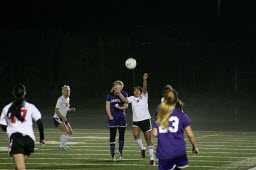 Anyssa DeVera rises up for the soccer during a misty Wednesday night, at Doc Harris Stadium. Camas beat Wenatchee 4-0 in the first round of the state tournament. (Camas Washougal Post-Record)