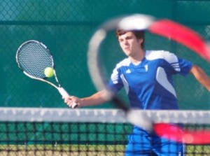 Mountain View's Colton Reed as seen though the racket of a Camas player in No. 1 doubles match, Oct. 8, 2014. (Jeff Klein photo)
