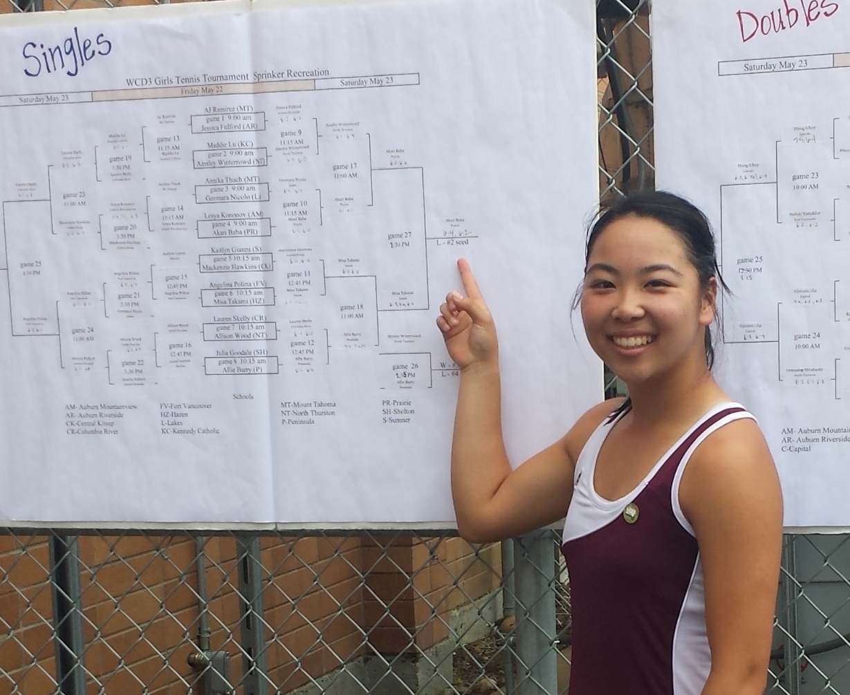 Prairie senior Akari Baba points to her name on the champions line at the 3A bi-district tournament.