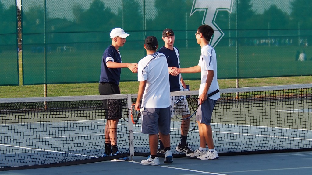 Skyview's Chris Sheppert, left, and Alex Osler shake hands with Mountain View's Nick Shiraishi and Edmund Hsu after winning the No. 2 singles match. (Jeff Klein/The Columbian)