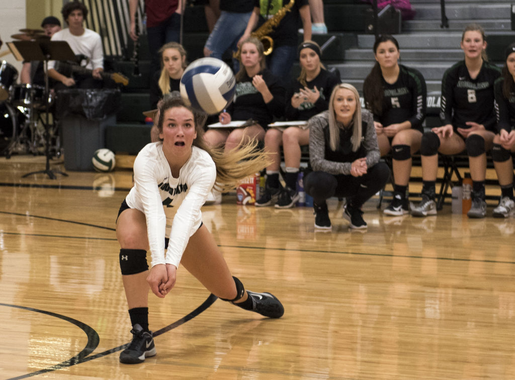 Woodland's Elyse Booker leaps forward for a dig during the match at Woodland High School on Tuesday evening, Oct. 17, 2017. Woodland won the match 3-1.  (Alisha Jucevic/The Columbian)