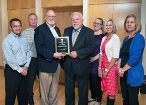 State Sen. Don Benton, R-Vancouver, receives a Proud Partner award from the Washington State Housing Finance Commission. 