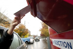 Voters use a drive-up collection box to cast their ballot Nov. 4, 2013 in downtown Vancouver, Wash.
