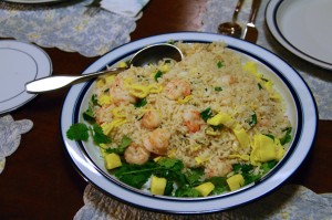 Serve Shrimp fried rice Vietnamese style with pineapple and garnish with cilantro.