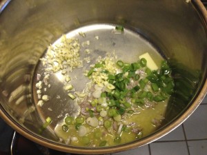 This is the beginning of broth for steamer clams. Note the unsalted butter that's melting, the garlic and not enough minced shallots. That's why the IO used green onions.