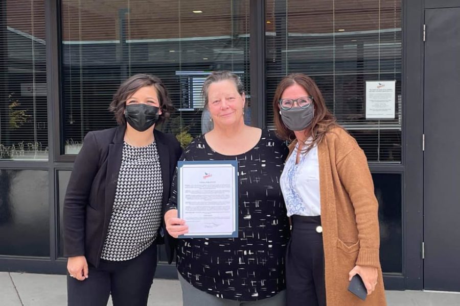 Abigayle Coleman (left), Kathleen Huber and Jill Karmy pose with a proclamation from the city of Ridgefield formally declaring June 2021 as its first-ever Pride Month.